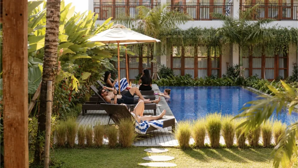Guests relaxing on poolside loungers