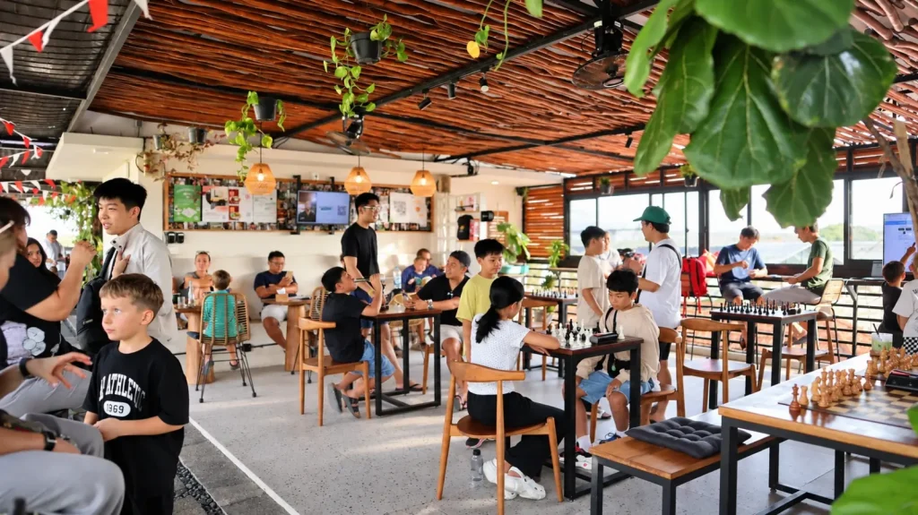 Players of all ages over chess boards in the rooftop eatery