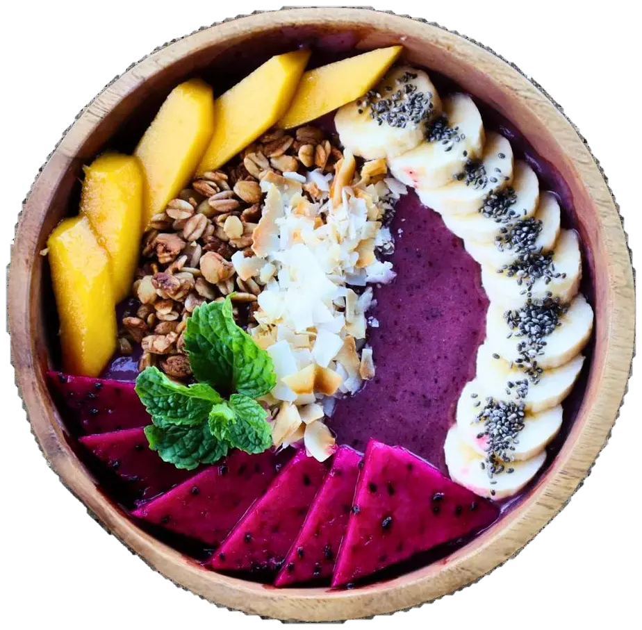 Smoothie bowl topped with mango, banana, granola, coconut and dragon fruit