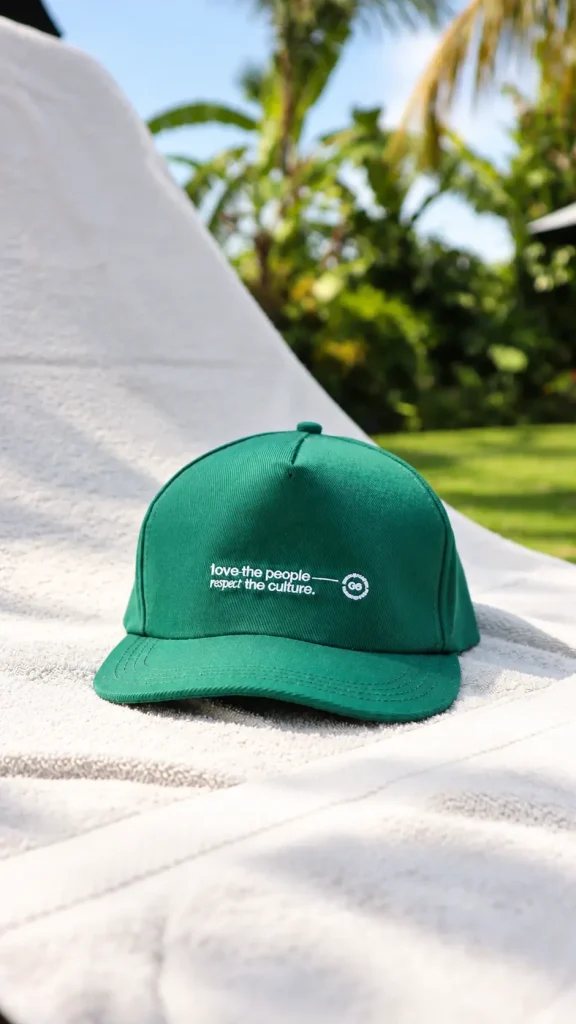 A green PUCO cap embroidered with love the people, respect the culture