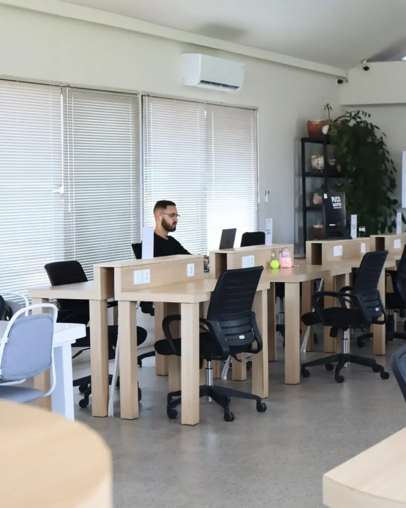 A row of dedicated desks with wooden dividers