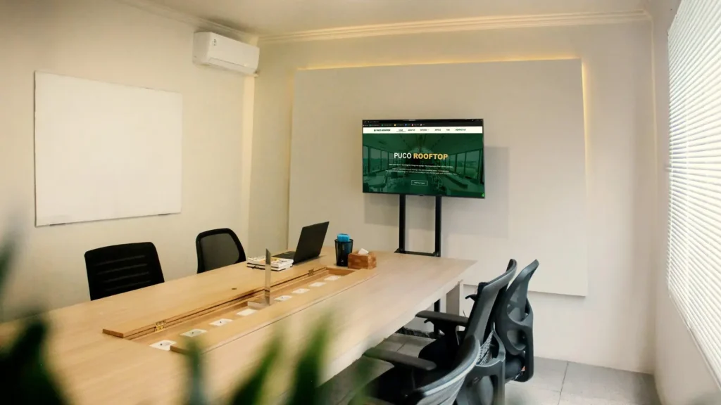 The Meeting Room, with a whiteboard, a Smart TV and a long table
