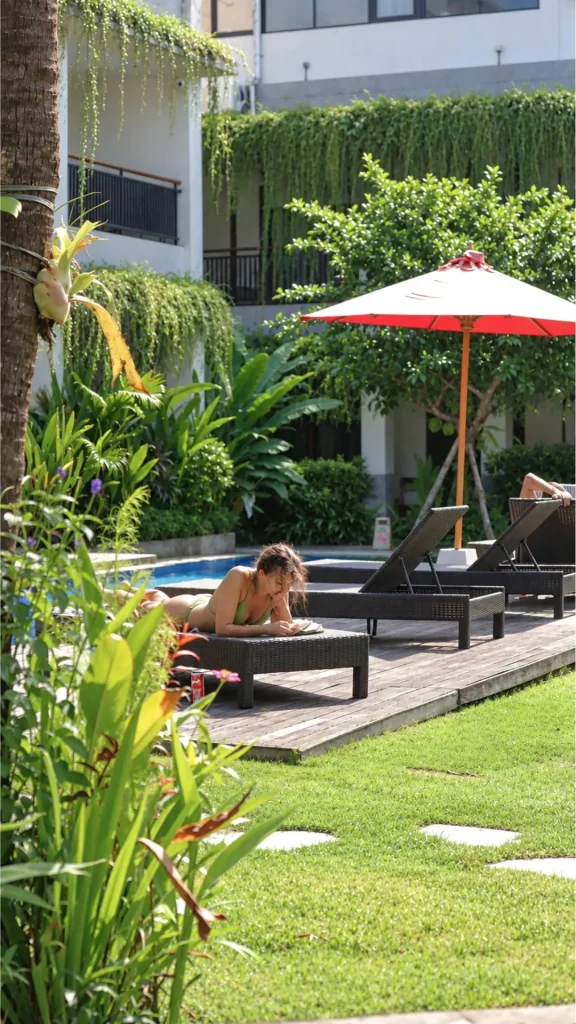 Reading on a sun lounger by the pool